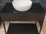 a black table with a white bowl on top of it