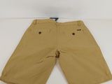 the children ' s shorts are tan and have buttons on them