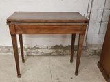 a small wooden table with a drawer on it