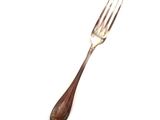 a fork that is sitting on a white surface