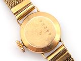 an image of a close up of a wrist watch on a white surface
