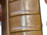 a brown suitcase sitting on top of a wooden chair