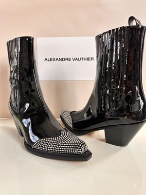 a pair of black ankle boots with crystals on them