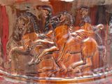 a vase with a picture of a group of horses on it
