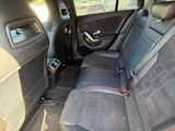 the back seats of a car are black with red stitching