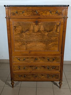 a wooden dresser with a marble top on a tiled floor