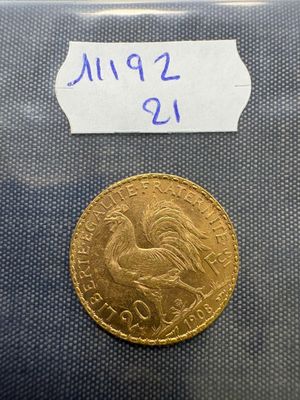 a close up of a gold coin with a label on it