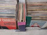 a lot of vinyl records in a box on the floor