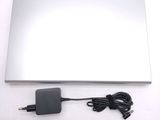 a laptop computer with a power cord attached to it
