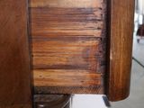 a close up of a drawer with a wooden handle