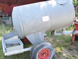 a large metal tank sitting on a trailer in the grass