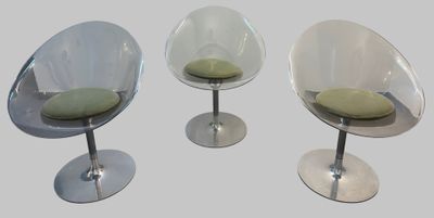three chairs with a green cushion on each of them