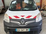 a white van with a red stripe parked in front of a building