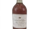 a bottle of wine sitting on top of a white table
