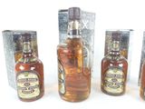 three bottles of liquor sitting next to each other on top of a table