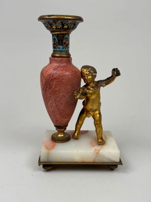 a statue of a boy holding a vase on a marble base
