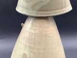 a white vase with a crown on top of it