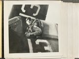 a black and white photo of a man in a plane