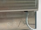 a close up of a metal box with a wire attached to it