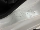 a close up of a car ' s front bumper with scratches on it