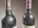 two bottles of wine sitting next to each other on a table