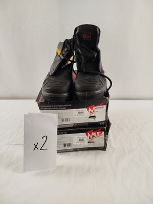 pair of black shoes sitting on top of a stack of boxes