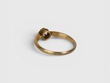 a close up of a gold ring on a white surface