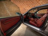 the interior of a car with the door open and the driver ' s seat up