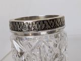 a glass jar with a ring on top of it