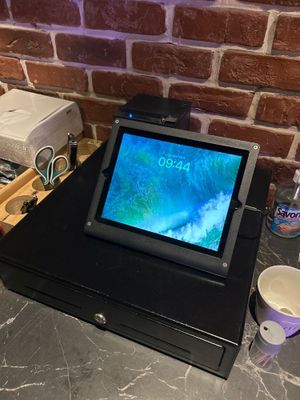 une tablette posée sur un socle noir