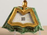 a picture of a green and gold picture frame on a table