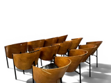 many chairs that are lined up in a row