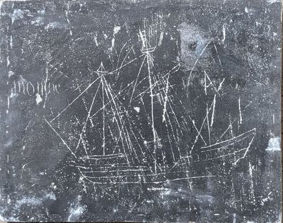 a black and white photo of a ship on a stone