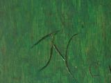 a close up of a green vase on a white table