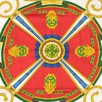 an image of a red and green table cloth with gold and blue decorations