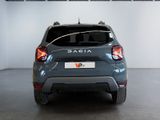 the back end of a grey car parked in a showroom