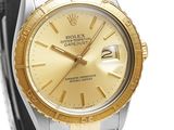 a watch with a gold dial on a bracelet