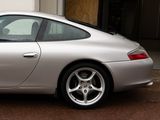 a silver sports car parked in front of a garage
