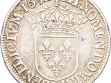 a silver coin with a crown on top of it