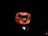 an orange diamond on a black surface