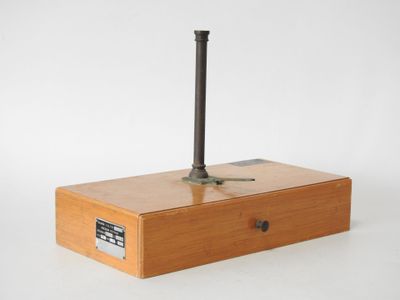 an image of a wooden box with a metal object on top