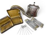 a silver case with a bunch of silver spoons in it