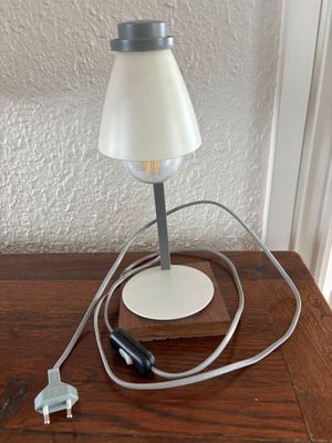 a lamp that is sitting on a table with a cord