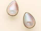 two pairs of pearl earrings on a beige background