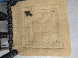a piece of burlock on a chair that has a picture of a sewing machine on it