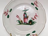 a plate with a picture of a woman and a dog on it