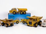 cinq camions miniatures alignés les uns à côté des autres