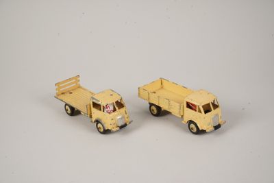 two toy trucks that are sitting next to each other