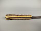 a chocolate and peanut butter sandwich on a wooden spoon