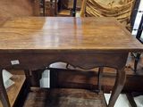 a table with a wooden top and a chair in front of it